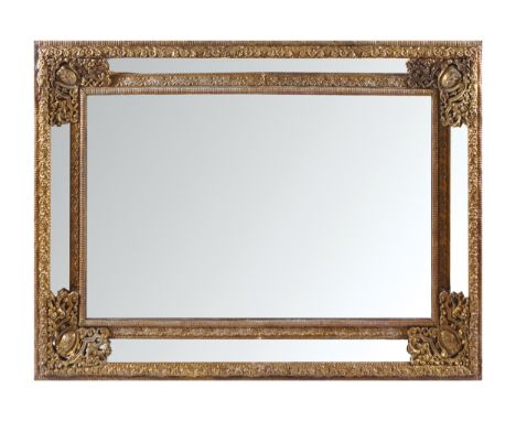 LARGE NINETEENTH-CENTURY BRASS FRAMED CUSHION MIRROR OVERMANTLEThe central rectangular plate surrounded by smaller plates wit