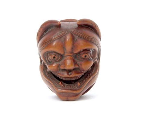 Japanese wooden netsuke finely modelled with a lady's smiling face to one side, the other wide with a dragon type mask, 3cm h