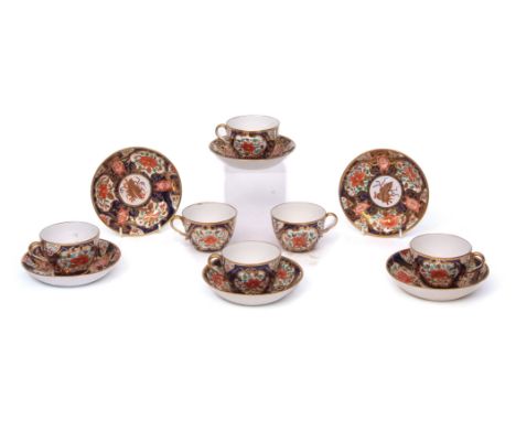 Group of six early English porcelain cups and saucers, finely decorated in an Imari style on a blue ground, the bases with pa