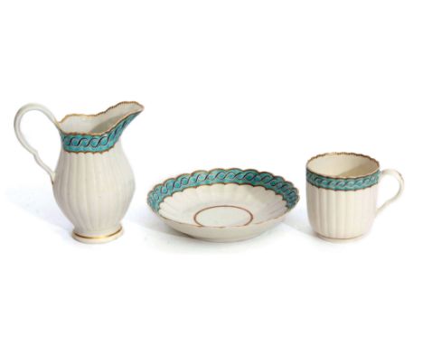 Worcester fluted cup and saucer, together with a matching milk jug, all with a French type design on green enamel with gilt r