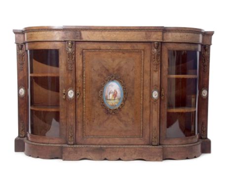 Victorian walnut credenza of break front form, the central door applied with a painted Sevres style panel, the uprights throu
