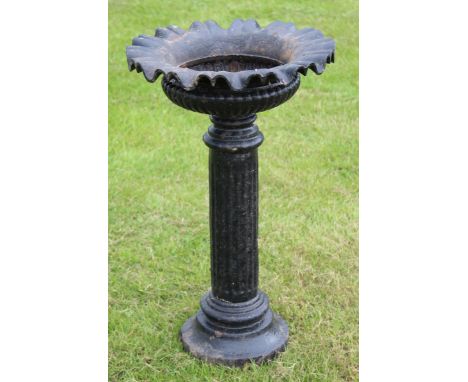 Victorian cast iron pedestal garden urn, of circular form with a crimped rim on a fluted and ring turned support, 41.5cm diam