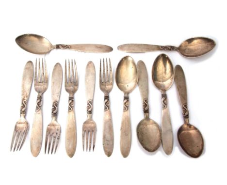 Six + six Danish mid-20th century spoons and forks, each of polished construction and with double struck dolphin motifs to th