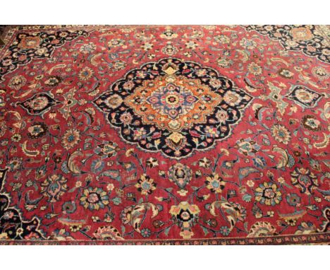 Late 20th century Caucasian large wool carpet, central floral lozenge within a multi-coloured border, mainly puce, blue and o