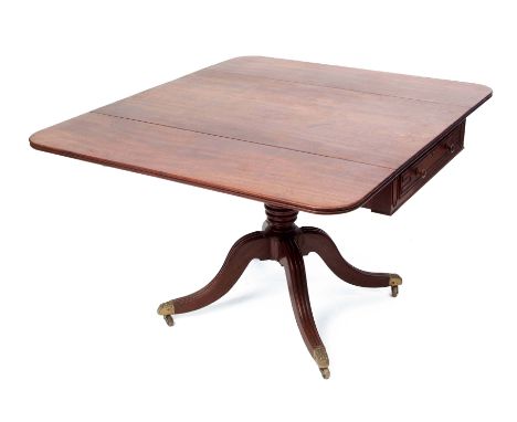 Regency period mahogany pedestal Pembroke table, two drop flaps raised on ring turned baluster support, terminating in a quad