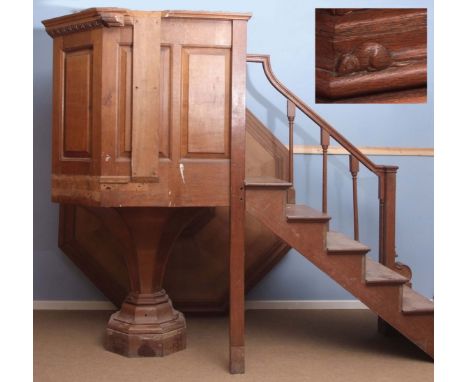 Mouseman oak pulpit of canted form, raised on a tapering pedestal, the large hexagonal plinth or canopy applied with a six-st