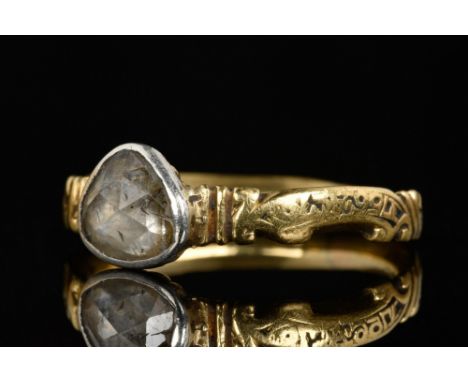 Circa 1800 AD. A slender gold ring with teardrop shaped bezel decorated with a sparking diamond. The band with ribbed decorat