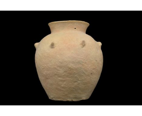 Ca. 3100-2900 BC. A storage vessel formed of a light terracotta with a spherically shaped body and seven protruding nodules f