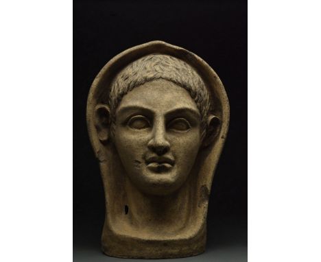 Ca. 400-200 BC.A terracotta votive of hollow form depicting a young male. His young visage comprises of large almond-shaped e