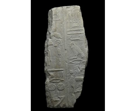 Ca. 2050-1786 BC. A large limestone carved in raised relief with two columns of hieroglyphs containing titles of an official,