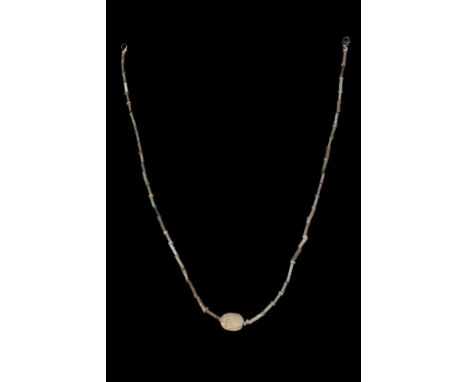 Late Period / Ptolemaic, Ca. 712-30 BC. A beautiful restrung necklace with tubular and discoid beads as well as a beautiful s