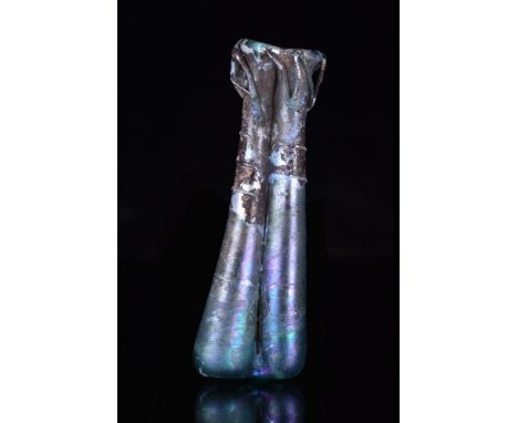 Ca. 200–300 AD. A double-tube glass balsamarium with decorative applied trails around both rims and bodies in a green-clue ti