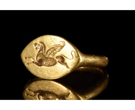 Ca. 400-300 BC. Hellenistic Period, possibly from Egypt. A beautiful gold finger ring composed of a round hoop and a large be