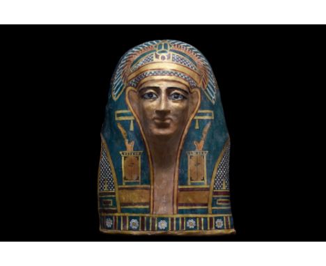 Ptolemaic Period, Ca. 332-30 BC. An ancient Egyptian cartonnage mask of timeless beauty depicting the deceased who is shown w
