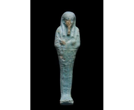 Late Dynastic Period, Ca. 664-332 BC. An ancient Egyptian blue faience ushabti. The mummiform figurine wears a tripartite wig