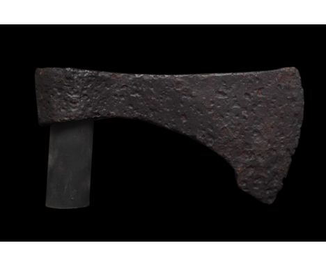 Ca. 900-1100 AD. An iron battle axe with a broad blade, tapering cheek and a round socket. The bearded axe was common from th