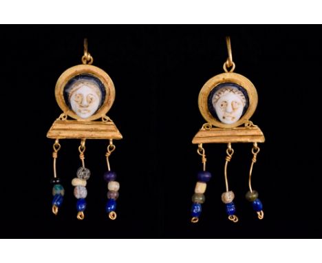 Ca. 1st-5th century AD. Pair of cameos depicting Medusa facing forward, set into gold earring bezzels with the suspension loo