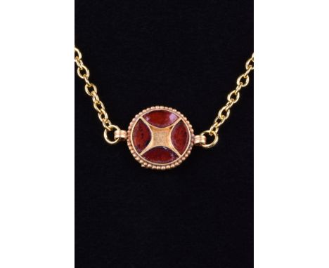 Ca. 500-700 AD. A beautiful circular gold pendant inset with garnets, framed with a beaded edge and flanked by a pair of oppo