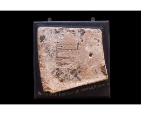 Ca. 2112-2095 BC. A nearly rectangular in shape brick fragment, inscribed with a central square of four columns of cuneiform 