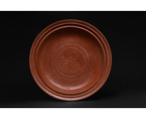 Ca. 300-400 AD. A large terracotta shallow plate or dish with its walls gently tapering to a low ring base. Between the rim a