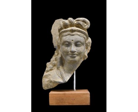 Ca. 200-300 AD. A richly carved in grey schist, combining naturalism of the classical Greek style with the Asian serenity of 