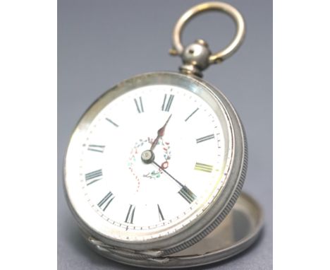 An 800 silver cased open face pocket watch. White ceramic dial with central floral design. Roman numeral markings. Key wound 