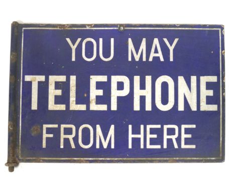 A metal and enamel telephone sign, of rectangular form, inscribed 'You may telephone from here' in bold white lettering on a 