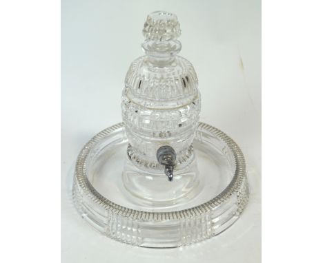 A cut glass ribbed and panel decorated liqueur decanter in the form of a barrel, set with a stopper and a base metal spigot, 