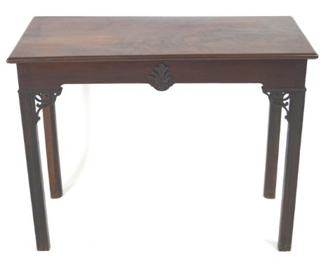 A Chinese Chippendale style side table in mahogany, of plain rectangular form, with shaped edge top over a frieze centred wit