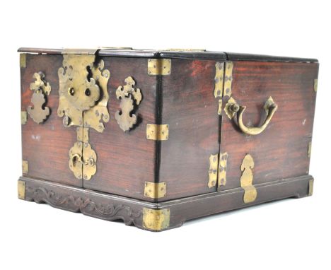 A brass bound Chinese hardwood travelling dressing table/box, of rectangular form, the top lifting to reveal an inset mirror 