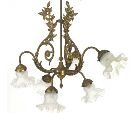 A gilt metal six light chandelier, with six frosted glass petal shaped shades issuing from leafy and s scroll branches, with 