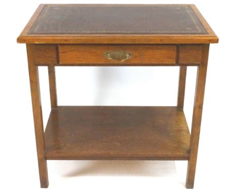 An oak library table with leather inset top, of plain rectangular form, the frieze set a plain drawer, raised on squared legs