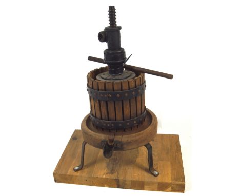 A miniature cider press, of traditional form, in light wood and iron, mounted on a board, 55cm high
