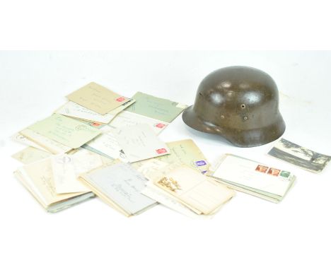 A Third Reich painted metal military helmet, with a pressed white metal cap badge, 17cm high x 23cm wide x 28cm deep, togethe
