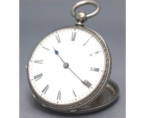 A sterling silver open face pocket watch. White dial with roman numeral markings. Engraved case. Key wound movement (key supp