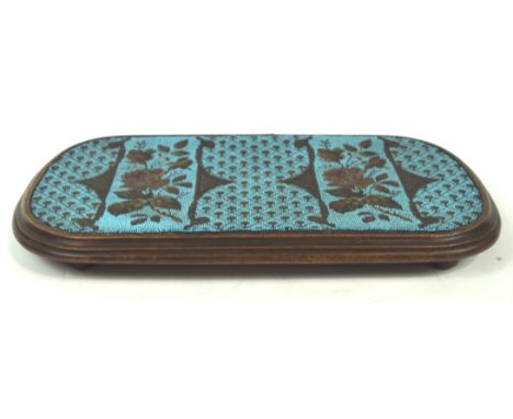 A 19th century mahogany and bead work kettle stand of rounded rectangular form the turquoise panel decorated with roses and d