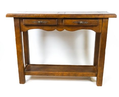 An oak console table with two frieze drawers, the square tapering legs linked by a shelf, 96cm high x 129cm wide x 45cm deep