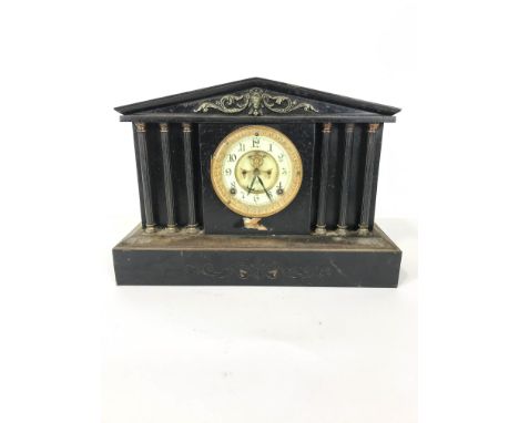 An early 20th century cast iron and brass mounted mantel clock,the case of architectural form, the enamel dial marked for Ans