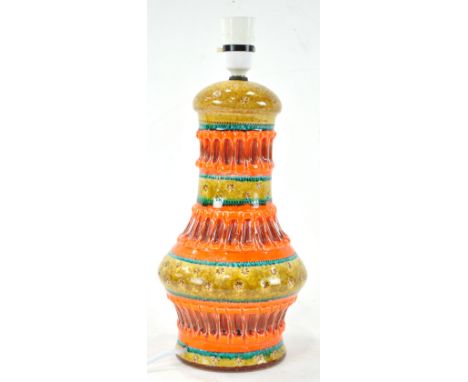 A 1960's Italian pottery Nuovo Rinascimento lamp base, having repeated patterns and banded orange and green glazes, 37cm high