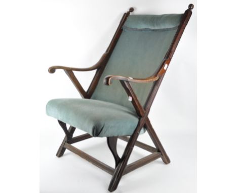 A late 19th century Victorian mahogany armchair, having a tall curved bracket with cushioned headrest and sprung seat, the ma