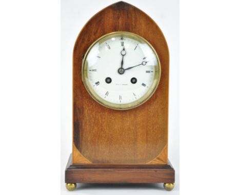 An Edwardian mahogany and boxwood strung lancet shaped mantel clock on gilt paw feet, 28cm high