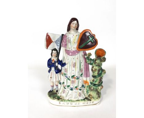 A Staffordshire pottery figure group the Band of Hope beside a tree trunk spill vase 34.5cm high