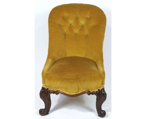 A Victorian button back nursing chair, on carved mahogany cabriole legs, 84cm high x 50cm wide overall