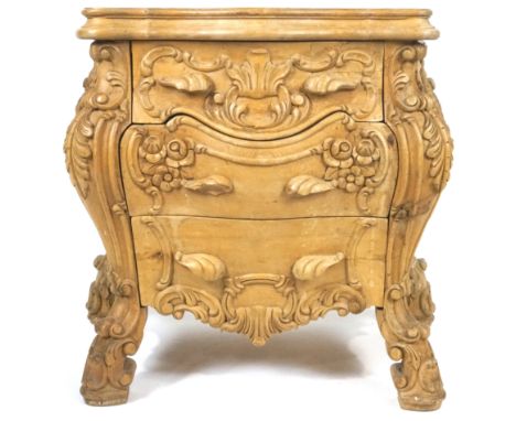 A French pine Louis XV style Rococo commode, deeply carved with acanthus, scrolls and flowers, with three graduated drawers, 