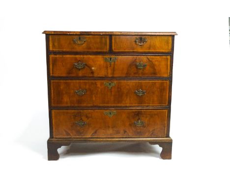 A George III veneered walnut chest of drawers with satinwood stringing with two short drawers above three graduated long draw