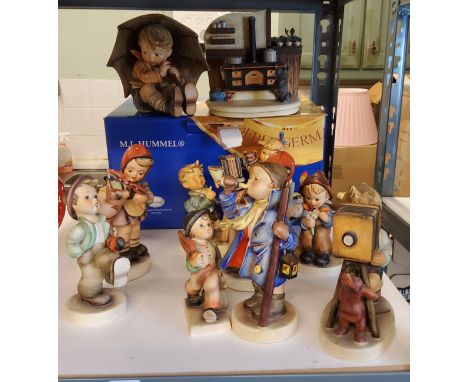 A Goebel figure, designed by M I Hummel, Umbrella Boy, 12.5cm high, printed mark;&nbsp; others, The Photographer;&nbsp; Merry