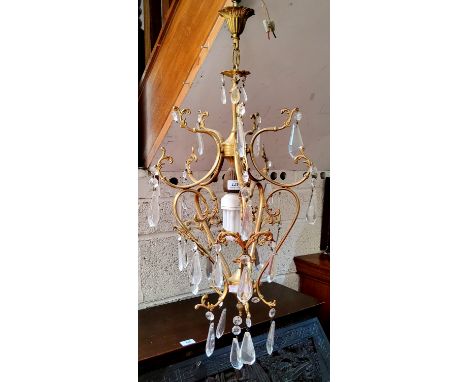 A 20th century gilt metal ceiling light, cast with leafy scrolls, prismatic clear glass lustres, 70cm high;&nbsp; a ceiling h