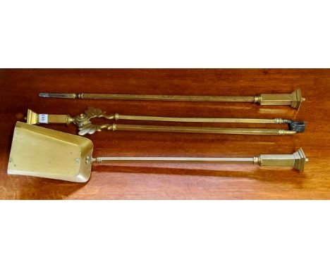 A set of three brass fireside implements and andiron, 70cm long (4) 