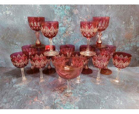 A set of seven ruby glass overlaid wine glasses, waisted columns, spreading circular bases, 12.75cm high, c.1920;&nbsp; anoth