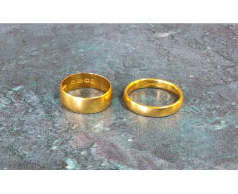 A 22ct gold half barrel band, size N; another size K 8.2g total (2) 